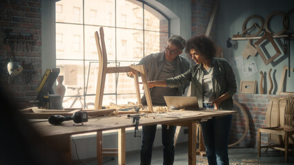 Small Business Owners of a Furniture Workshop Using Laptop Computer and Discussing the Design of a...