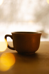 Fototapeta premium coffee mug on the table, Bokeh effect