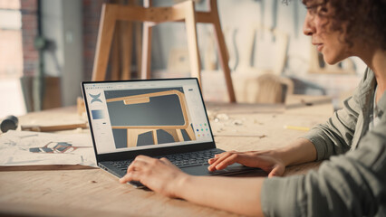 Woodcraft Artist Working on Laptop Computer, Creating a Digital 3D Model of a Stylish Wooden Bedside Table. Creative Multiethnic Female Preparing a Design for Carpentry Project on a Screen.