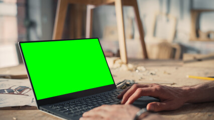 Close Up Shot of a Person Using Laptop Computer with Green Screen Chroma Key Display. Creative Man...