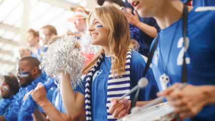 Fototapeta premium Sport Stadium Big Event: Beautiful Cheering Girl. Crowd of Fans with Painted Faces Cheer, Shout for their Blue Soccer Team to Win. People Celebrate Scoring a Goal, Championship Victory