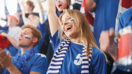 Fototapeta premium Sport Stadium Big Event: Beautiful Cheering Girl. Crowd of Fans with Painted Faces Cheer, Shout for their Blue Soccer Team to Win. People Celebrate Scoring a Goal, Championship Victory