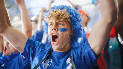 Sport Stadium Event: Caucasian Man with French Flag Painted on Face Cheering for His Team to Win....