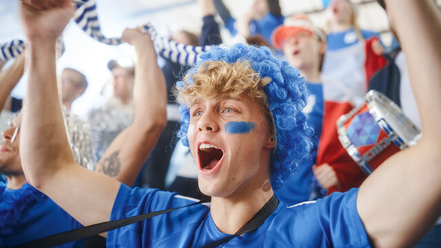Sport Stadium Event: Caucasian Man with French Flag Painted on Face Cheering for His Team to Win. Crowd of Happy Fans Shout after Goal Score. People Celebrate Championship Victory
