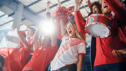 Sport Stadium Event: Crowd of Fans Cheer for their Red Soccer Team to Win. People Celebrate Scoring a Goal, Championship Victory. Group of Friends with Painted Faces Cheer, Shout, Have Emotional Fun