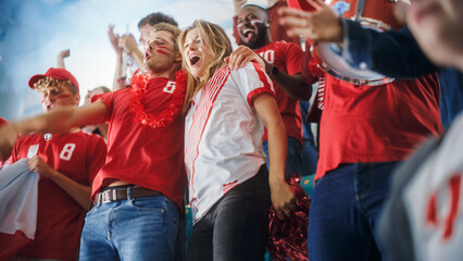 Sport Stadium Big Event: Crowd of Fans Cheer for Red Soccer Team to Win. People Celebrate Scoring a...