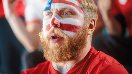 Sport Stadium Sport Event: Portrait of Handsome Man with U.S. Flag Painted Cheering for Red Americn...