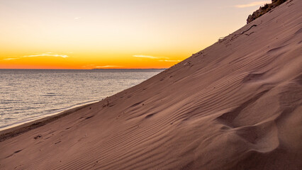 magical sunset on big sand dune over the sea