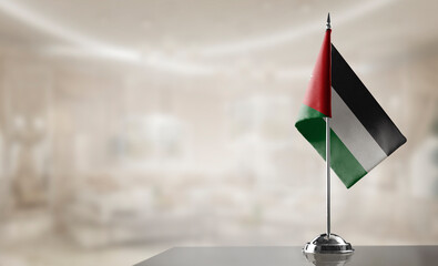 A small Jordan flag on an abstract blurry background