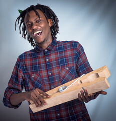 Portrait, prop and happy man holding giant peg looking cheerful on a grey studio background. Face,...