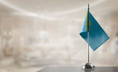 A small Kazakhstan flag on an abstract blurry background