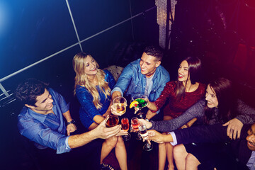 Party, celebration and friends toast in nightclub enjoy partying, clubbing and happy hour on new...