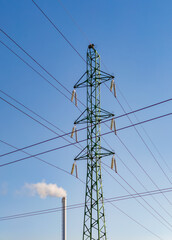 Factory chimney with smoke. Industrial pipe. Blue sky at sunny day. Air pollution. power line tower