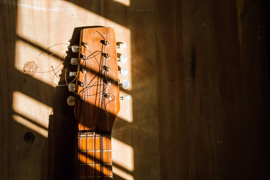 charango on a wooden table illuminated by the window sun.
