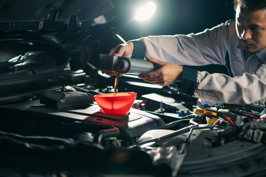 the technician maintained and refilled the lubricant for the car's engine in the garage. the concept of engineering, transportation, petroleum and automobiles