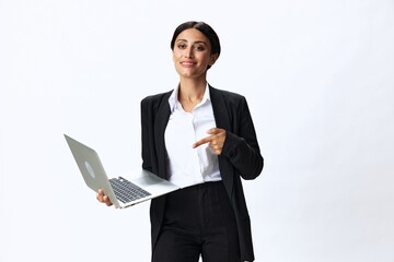 Business woman with laptop in hand in black business suit shows signals gestures and emotions on white background, freelancer job online training