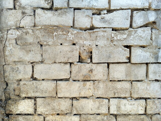 Old cinder block wall texture with crumbled seems
