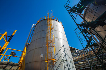 Stainless steel silos in the chemical industry, bulk plastics silo.