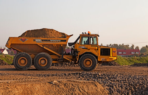 Umea, Sweden - September 6, 2019: a wheel loader transporting sand for construction