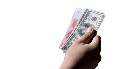 Isolated hand holding banknotes of Yuan and US Dollar with clipping paths.