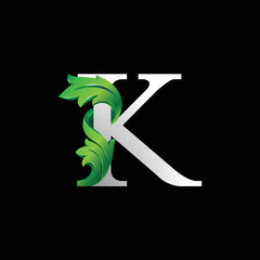 Initial letter K, 3D luxury green leaf overlapping white serif font on black background