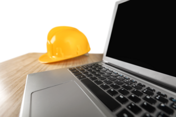 Engineer office working desk with hard hat and computer