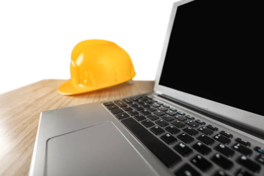 Engineer office working desk with hard hat and computer