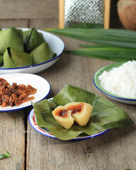 Sweet Stuffed Dough with Pyramid Shape or Kanom Tian Kaew on Wooden Table, Thai Dessert