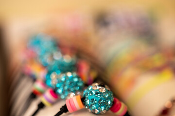 Fototapeta premium Bracelets made of small blue beads, photograph taken with reduced depth of field.