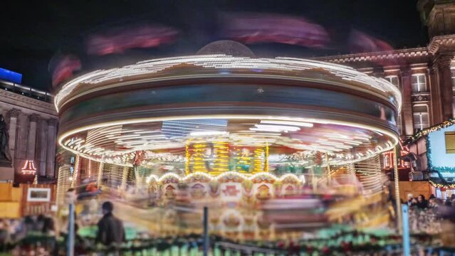 Christmas carousel time lapse loop.
Speeded up merry go round at night. Loops.