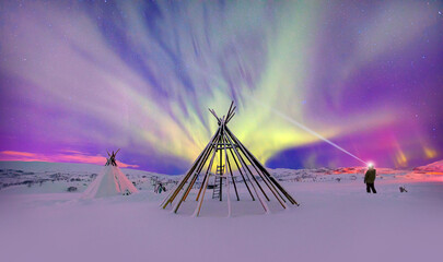 A man illuminates the sky with the lantern - Northern lights or Aurora borealis in the sky with  -...
