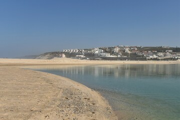Seaside town of Foz do Arelho, Portugal, Óbidos lagoon on the right, fine yellow sand dunes and beaches to the left, seen from Praia do Bom Sucesso beach, on a lovely calm and sunny autumn day