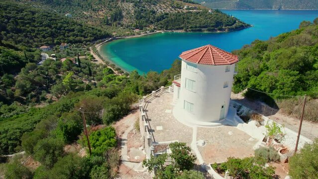 Traditional Greek windmill and Paralia Dexia bayon Ithaca island, Greece