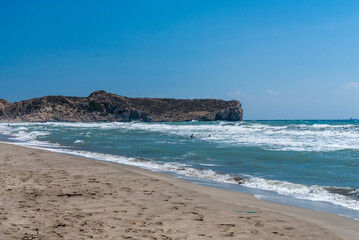Coast of Mediterranean Sea. Turquoise foamy waves. Sand beach. Close-up. Sunny autumn day. Fethiye, Turkey.