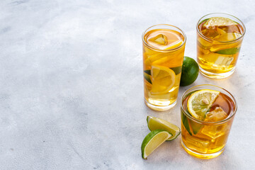 Alcoholic cocktails with oganges and ice in glasses. Alcoholic drinks background