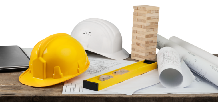 Blueprints and tools with hardhats on construction blueprint