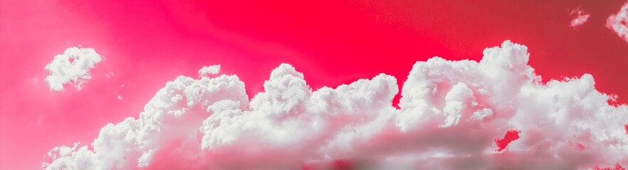 Bright Toned Purple Panorama Of Cloudy Sky. Natural Day Cloudy Sky Abstract Background. Panorama Panoramic View. Backdrop. Copy Space. Red, Magenta, Pink, Fuchsia Colors.