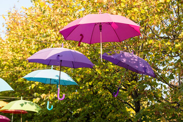 Fototapeta na wymiar Colorful umbrellas hung above the street.