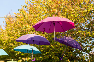 Fototapeta na wymiar Colorful umbrellas hung above the street.