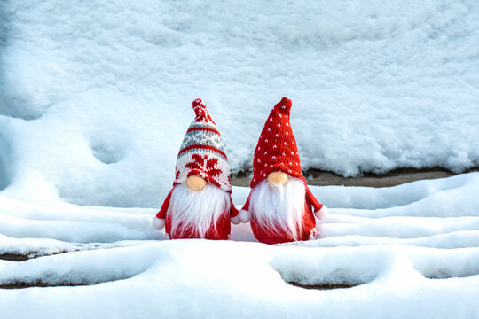 Christmas holiday card Cute scandinavian gnomes with red hat and white beard on snowy winter bench Fairytale snowfall Wintertime Hello December, January, February concept Happy New Year, Christmas