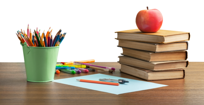 A school desk with stack of books and stationery