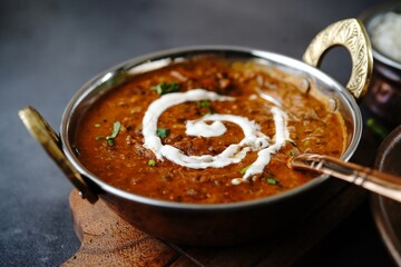 Dal Makhani | Indian vegetarian black lentil curry served in kadai, selective focus