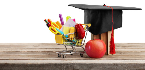 Graduation hat with colorful supplies on desk