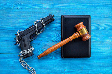 Black gun weapon in chains. Illegal use of weapons concept