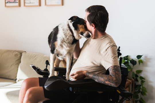 Disabled Man With His Dog At Home