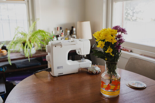Flowers and sewing machine on table