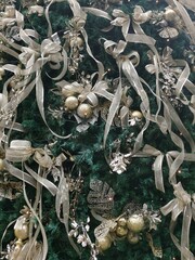 Full frame Christmas background with tree, gold ribbon and baubles