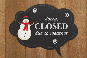 Sorry closed due to weather talk bubble chalk sign with snowman