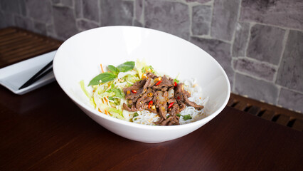 Asian combo plate with beef, noodles, rice and vegetables.