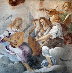 DOMODOSSOLA, ITALY - JULY 19, 2022: The baroque fresco of angels with the music instruments in the...